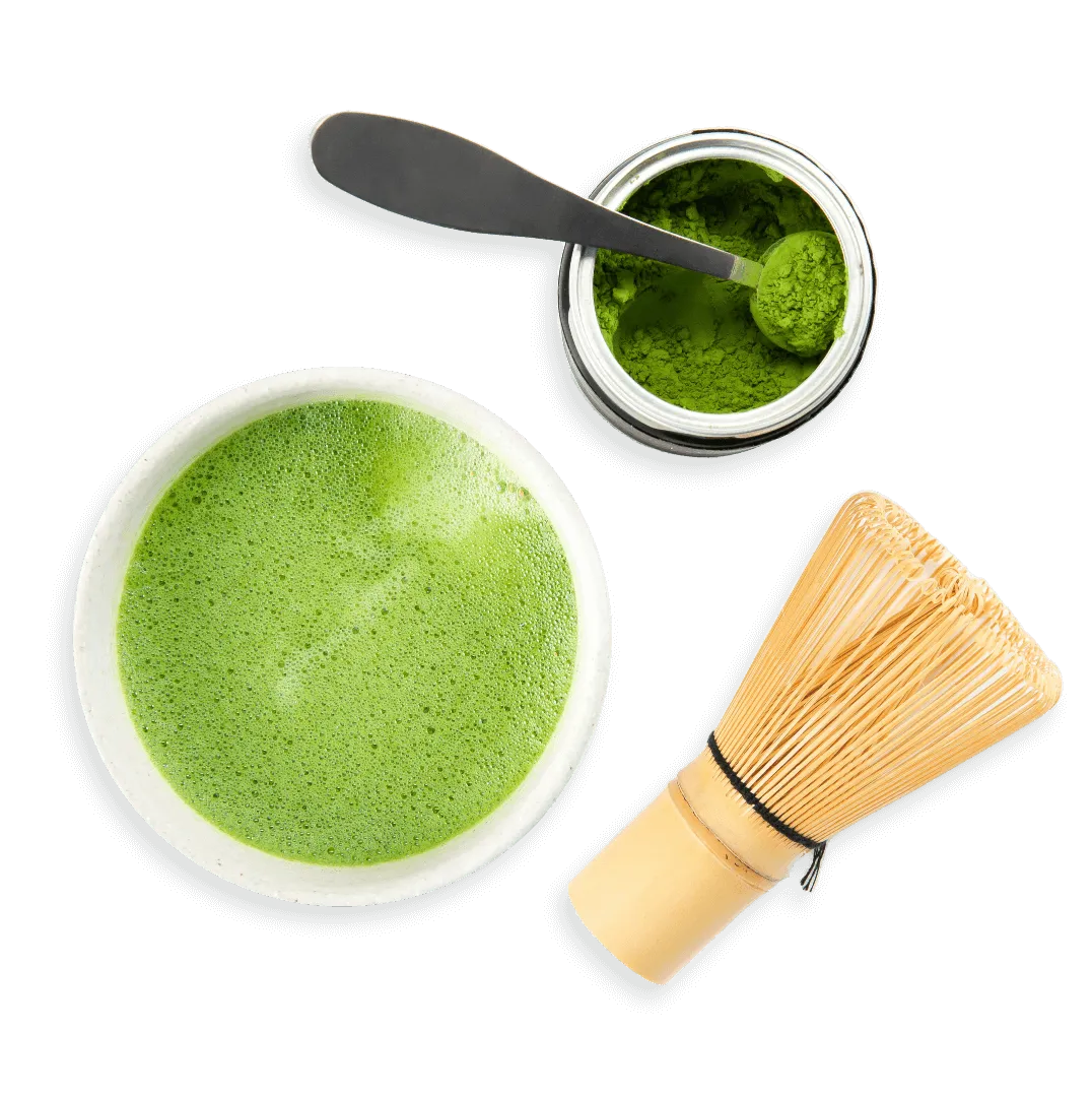 Overhead shot of a cup of green juice, green powder being scooped from its container, and a wine cork